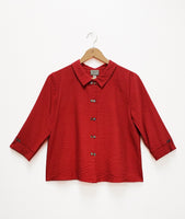 boxy crimson button down top with a twin button detail along the front, back and sleeve cuffs
