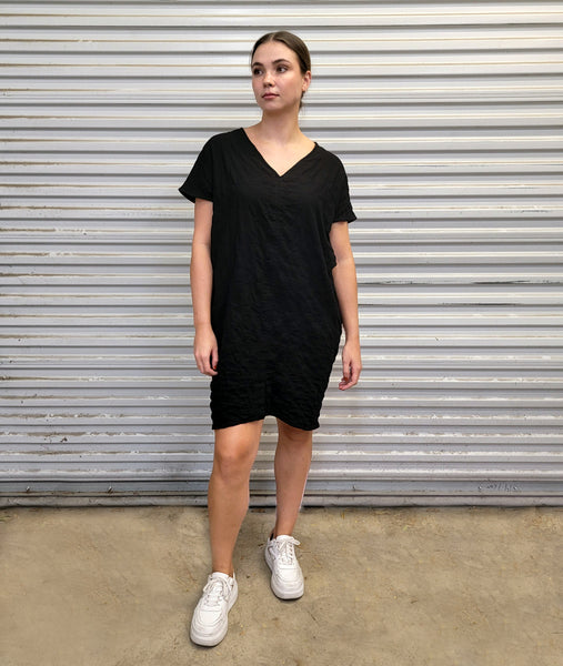 model in a black pull over boxy dress 