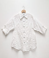 white textured button down blouse with rolled sleeves
