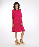 model in a pink extra large check print pullover dress with a rounded neckline, elbow length sleeves and a rounded hemline 