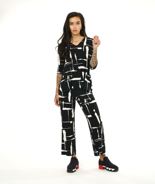 model in a black and white brushstroke print top with v-neck, 3/4 sleeves and a matching straight leg pant