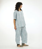 model in a silvery blue pullover top with a matching wide leg pant with an oversized pocket and tapered ankle