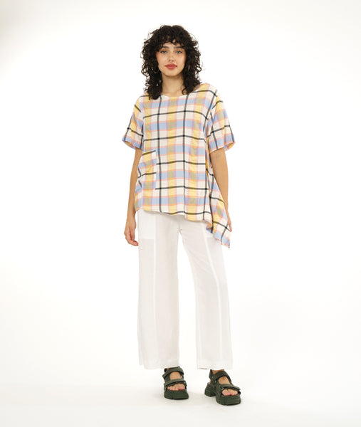 model in a straight leg white pant with an asymmetrical plaid print pullover top with short sleeves, a rounded neckline and a single hip pocket