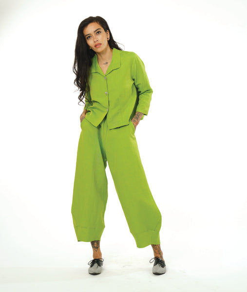 model in a wide leg lime pant with a tapered ankle, worn with a matching button down jacket with an open collar and long sleeves