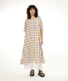 model in a midi length multi-color plaid dress with a short sleeve, rounded neckline and a contrasting hip pocket, worn over a pair of wide leg white pants