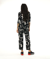 model in a black and white brushstroke print top with v-neck, 3/4 sleeves and a matching straight leg pant