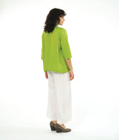 model in a wide leg white pant with a boxy lime button down blouse with a 3/4 sleeve and a small meandering collar