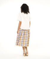 boxy white pullover top with a multi color plaid skirt