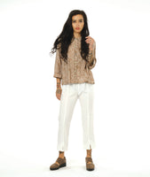 model in a straight leg white pant worn with a taupe leaf print button down blouse with a twin button detail and 3/4 sleeves