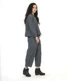 model in a grey and black textured pinstipe button down blouse with long sleeves, worn with a matching wide leg pant