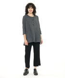 model in a grey and black pinstripe tunic length top with squared hip pockets, 3/4 sleeves and large round buttons down the placket, worn with a black slim pant