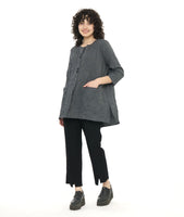 model in a grey and black pinstripe tunic length top with squared hip pockets, 3/4 sleeves and large round buttons down the placket, worn with a black slim pant