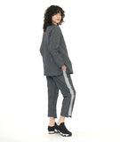 model in a grey and black textured pinstipe top with a contrasting panel in the front in a grey and white stripe. worn with a matching pant with a contrasting tuxedo stripe on the side