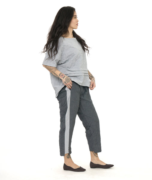 model in a grey and white textured pinstipe top with, worn with a matching pant with a contrasting tuxedo stripe on the side