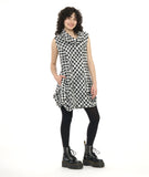 model in a sleeveless black and white plaid tunic with an oversized cowl neck, full length princess seams, and dramatic pleating at the hip seams. worn with black leggings and boots