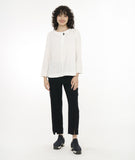 model in a black slim cut pant with a center front seam and split at the ankle, worn with a white pullover top