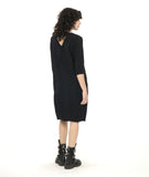 model in a black knee length shift dress with 3/4 sleeves, a squared neckline and pockets set in to the side seams