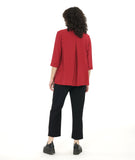 model in a slim black pant with a crimson red long button down blouse with 3/4 sleeves, with a twin button detail on the placket and sleeve cuffs