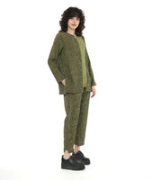 model in a black and green slim pant with a contrasting tuxedo stripe and stair strep hem. worn with a matching pullover top with long sleeves, a contrasting panel at the front center, and a round neckline with a split v cutout