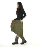 model in a green and black contrasting panel skirt with a tulip shape. worn with a black mock turtleneck