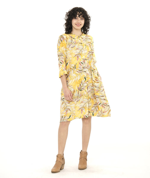 model in a yellow floral print shirt dress with a 3/4 sleeve