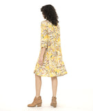 model in a yellow floral print shirt dress with a 3/4 sleeve