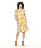 model in a yellow floral print shirt dress with a 3/4 sleeve