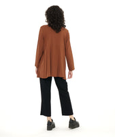 model in a slim black pant with a rust color button down blouse with an adjustable gather detail at each hip