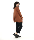 model in a slim black pant with a rust color button down blouse with an adjustable gather detail at each hip