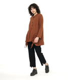 model in a slim black pant with a rust color button down blouse with an adjustable gather detail at each hip