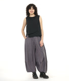 model in a black layered front sleeveless top, worn with a ultra wide leg pant with a slightly tapered ankle