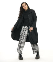 model in a black tee, black and white plaid pants, worn with a black jacket with a gathered bottom hem and pockets, collar and long sleeves