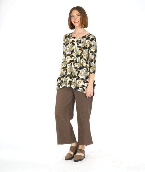 model in a floral print tee with a wide leg brown pant