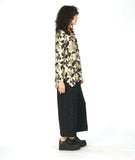 model in a wide leg circle print black pant with a floral print pullover top in a floral print with a v-neck, long sleeves and a high-low hem with a split at the sides