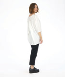 model in a slim black pant with a white 3/4 sleeve tunic with a rounded neckline with a v-split in the front center. top as a high-low hem