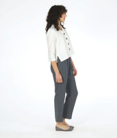 model in a short white button down with 3/4 sleeves, worn with a slim grey pant 