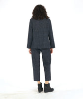 model in a grey and black striped pant with a contrasting tuxedo stripe, worn with a matching button down blouse with long sleeves and a full body with contrasting godets