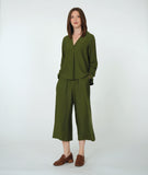 model in a wide leg green pant with a matching pullover top