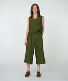 model in a wide leg short green pant with a matching half tucked in tank top