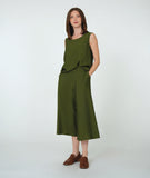 model in a wide leg short green pant with a matching half tucked in tank top