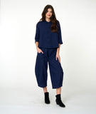 model in a wide leg blue and black striped pant, with a matching button down blouse