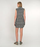 model in a black and white striped tunic with pleating at the hips and a cowl neckline