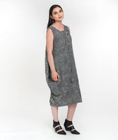 model in a black and white striped sleeveless dress with asymmetrical tucks