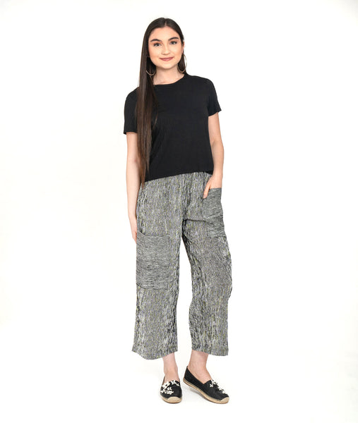 model in a plain black tee with a white and black striped straight leg cargo pant