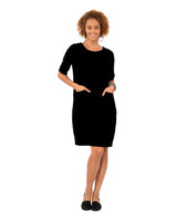 model in a black shift dress with princess seams and angled hip pockets