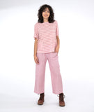 model in a red and white striped top with a matching pant in a pinstripe
