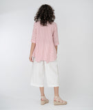 model in a red and white striped top with a white, wide leg cropped pant