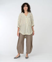 model in a wide leg brown pant and a yellow, white and grey stripe button down blouse