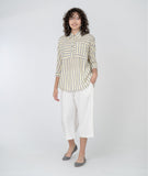 model in a grey, white and yellow striped top with a wide leg cropped white pant