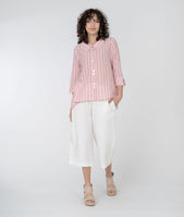 model in a wide leg white cropped pant with a red and white striped button down blouse